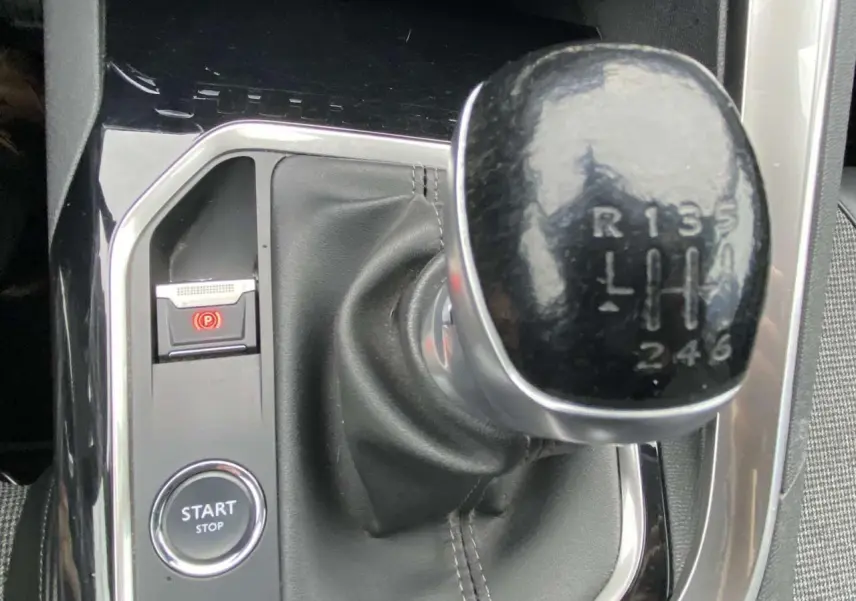 Gros plan sur le levier de vitesse manuel noir du Peugeot 3008 avec bouton Start/Stop et frein à main électronique.