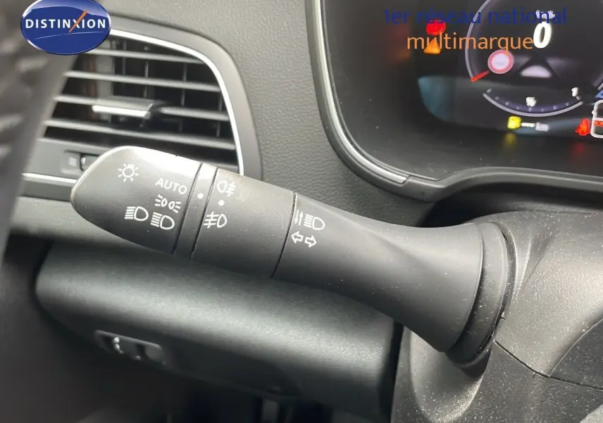 Le commodo d'éclairage noir du tableau de bord d'une Renault Mégane Break gris Highland Metal, vue intérieure.