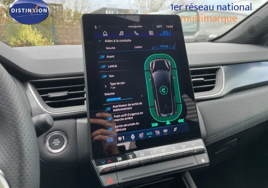 Vue intérieure centrée sur l'écran tactile du tableau de bord de la Renault Symbioz gris cassiopée, affichant l'aide au stationnement.