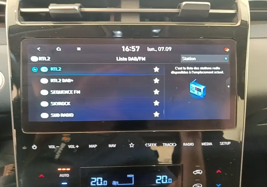 Écran tactile central du tableau de bord du Hyundai Tucson bleu, affichant la liste des stations radio.