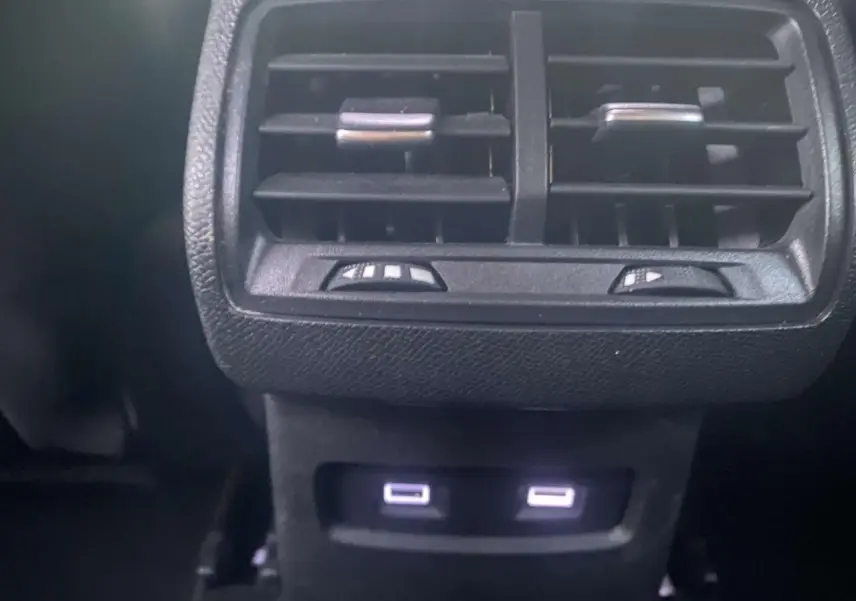Prises USB arrière éclairées sous les aérateurs noirs dans l'habitacle de la Citroën C4 blanche 2021.