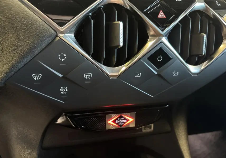 Détail du tableau de bord du DS3 Crossback 2024, avec boutons de commande et bouton start/stop illuminé, finition noire.