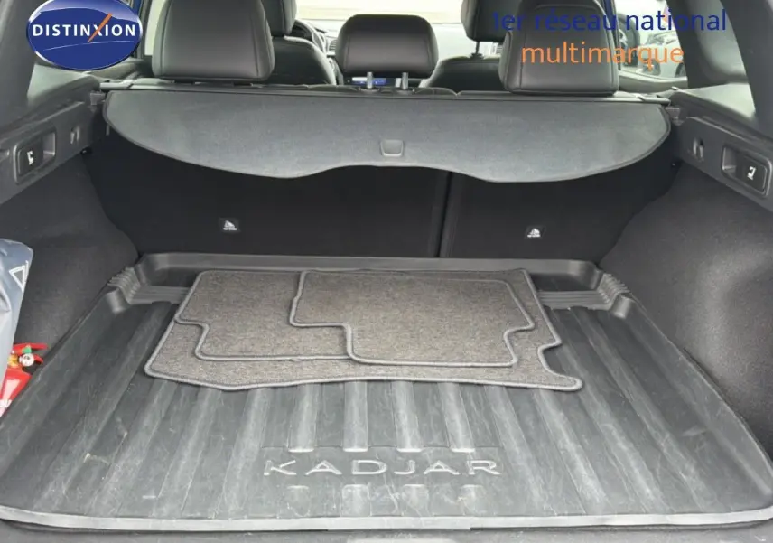 Coffre ouvert d’un Renault Kadjar 1.5 Blue dCi 115ch Intens 2021, tapis de sol et cache-bagages visibles.