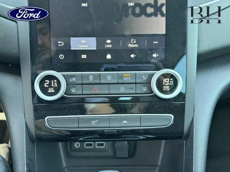 Gros plan sur la console centrale de la Renault Mégane 1.5 Blue dCi 115ch Techno EDC 2023, avec commandes climatisation bi-zone et écran tactile.