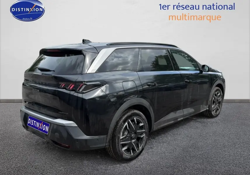 Peugeot 5008 noir vue 3/4 arrière droit, jantes alu et toit avec inserts argentés visibles.