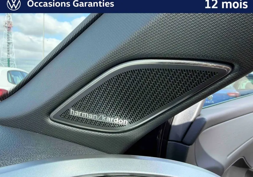 Gros plan sur le haut-parleur Harman Kardon côté droit de l’habitacle du Volkswagen T-Roc noir.