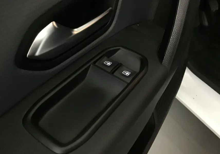 Gros plan sur les commandes de lève-vitres côté conducteur d'un Renault Express Van blanc 2023, finition Confort.