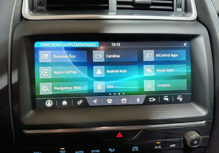 Écran tactile central du tableau de bord noir du Jaguar E-PACE P200, affichant les fonctions connectées.