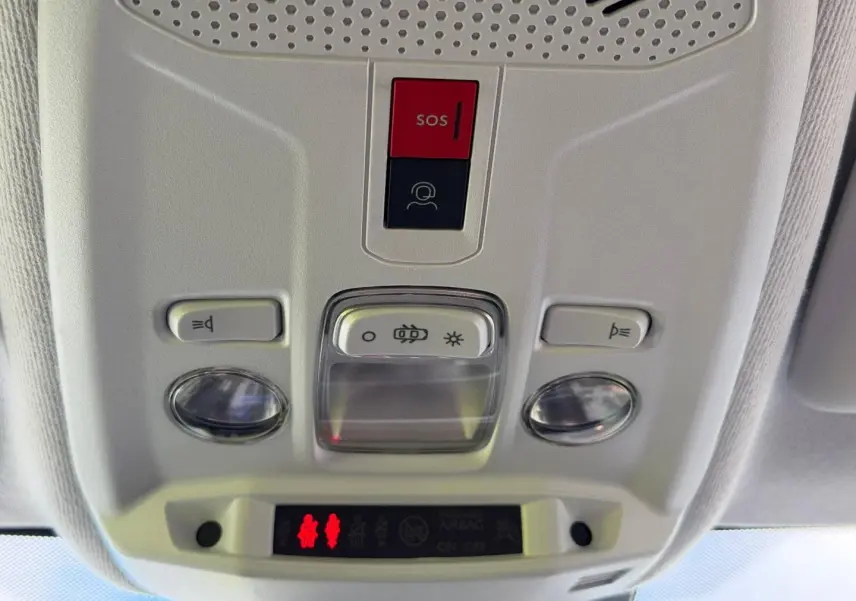 Vue en gros plan du plafonnier intérieur gris clair avec boutons SOS et éclairage de la Peugeot 208 2025.