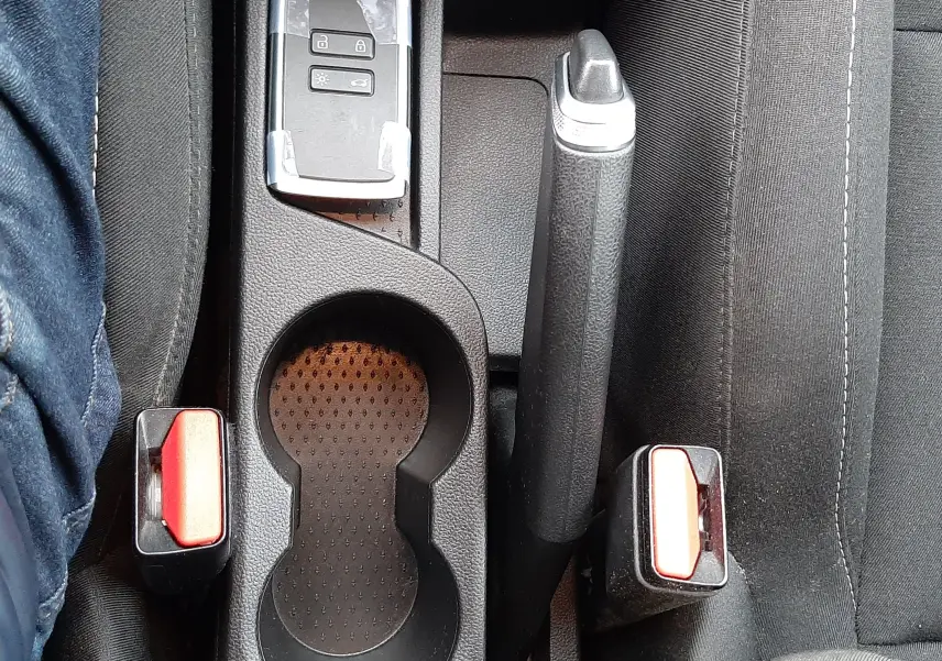 Vue plongeante sur la console centrale noire du Renault Captur 2020 avec clé, frein à main et ceintures de sécurité visibles.