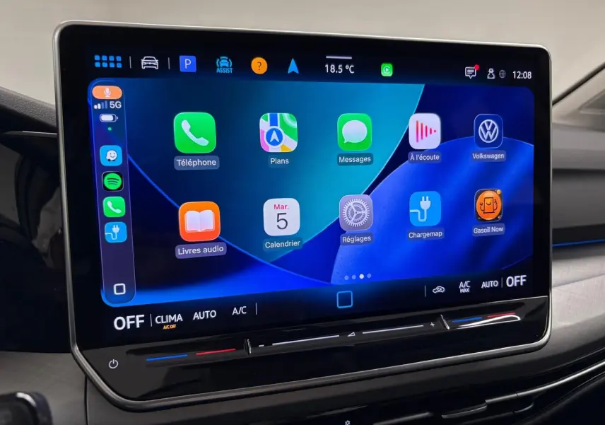 Écran tactile central affichant les applications connectées dans l'habitacle d'une Volkswagen Golf 2025 reflet d'argent.