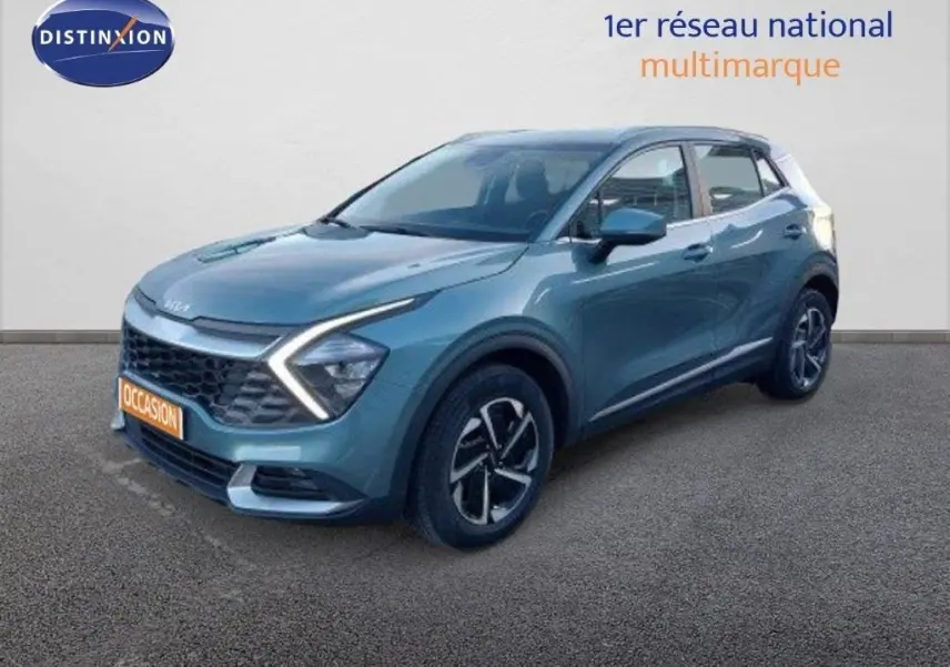 Vue 3/4 avant d'un KIA Sportage gris Sirius metal avec feux LED en forme de flèche et jantes bi-ton.