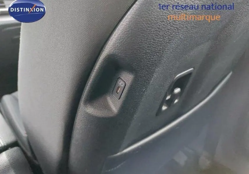 Détail du port USB intégré au dossier du siège arrière d'un Kia Sportage gris Sirius Metal 2024.