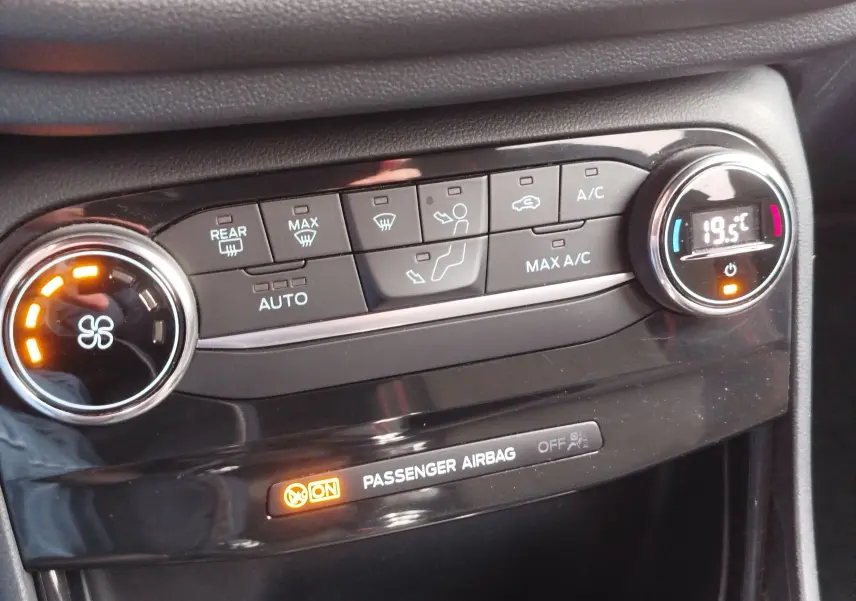 Détail de la console de climatisation du Ford Puma 2021 en gris, avec réglage digital à 19,5°C et ventilateur actif.