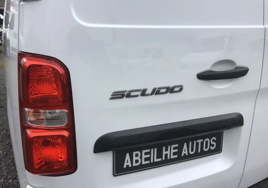Gros plan sur l’arrière gauche blanc du FIAT Scudo Fourgon avec feux rouges et poignée noire.