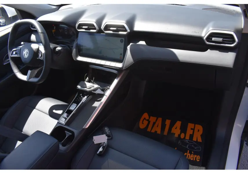 Vue intérieure côté conducteur du MG ZS blanc 2026, mettant en valeur le tableau de bord moderne et l'écran tactile central.