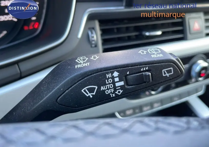 Gros plan sur le commodo d'essuie-glace de l'Audi A4 Avant gris Manhattan, avec tableau de bord et aérateurs en arrière-plan.