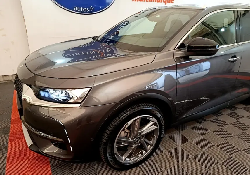 Vue 3/4 avant droit du DS7 Crossback E-TENSE 4x4 300 gris foncé avec phares LED et jantes alliage distinctives.
