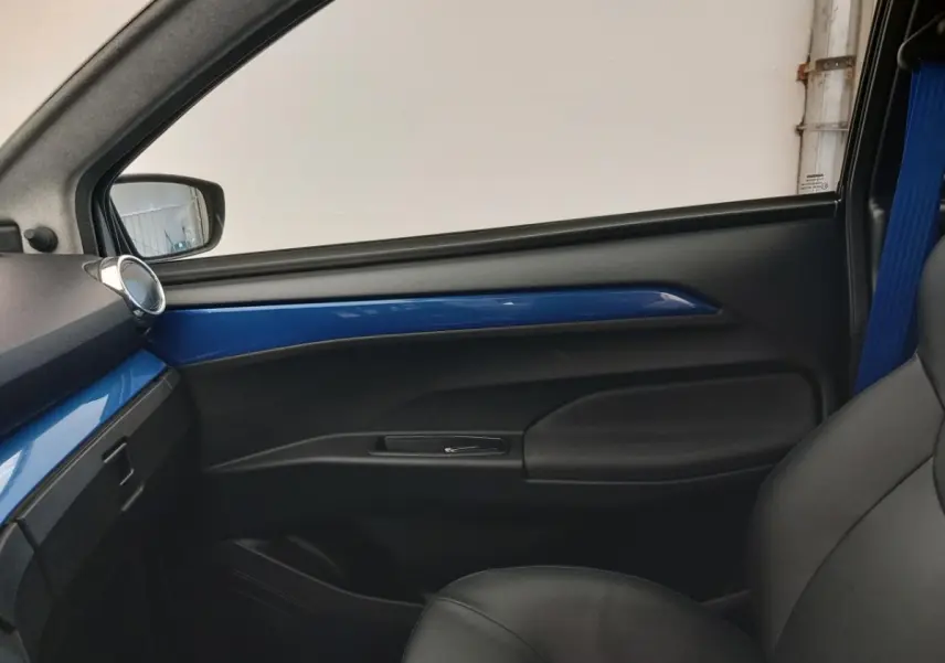 Vue intérieure côté passager de l’AIXAM MEGA E-SCOUTY EVO 2026 avec garniture bleue et siège noir.