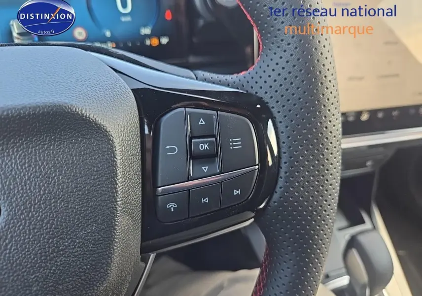 Gros plan sur le volant perforé avec commandes intégrées du Ford Puma gris cactus 2025, finition st-line.