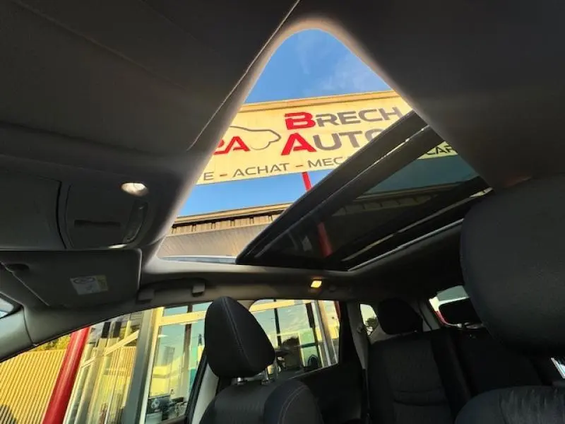 Vue intérieure du Nissan X-TRAIL 2018 noir avec toit ouvrant panoramique et sièges en tissu graphite.