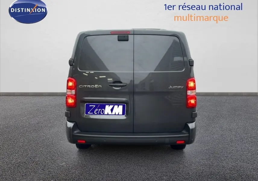 Vue arrière d’un Citroën Jumpy Cabine Approfondie gris titane métal, avec feux allumés et portes battantes fermées.