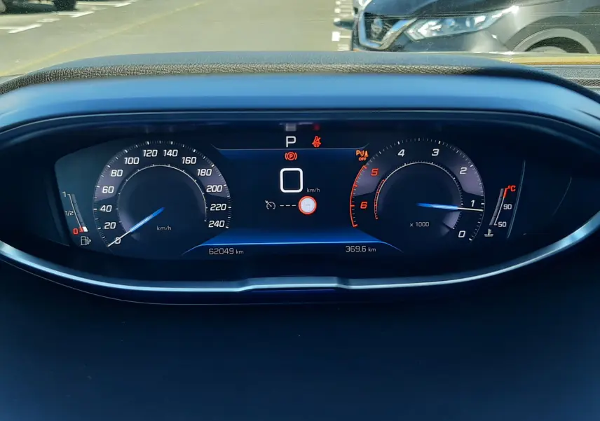 Tableau de bord numérique du Peugeot 3008 gris platinium, affichant vitesse, compte-tours et température moteur.