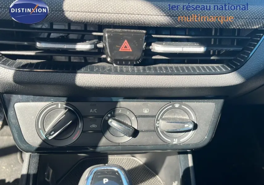 Gros plan sur la console centrale d’une Skoda Fabia 2025 en Reflex Silver, montrant les commandes de climatisation et le levier de boîte automatique.
