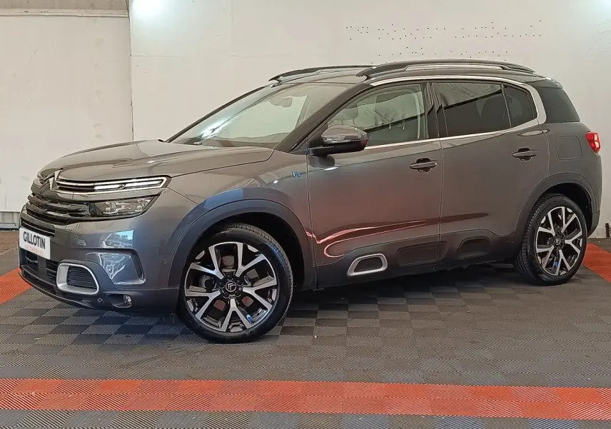 Citroën C5 Aircross Hybrid gris foncé en vue profil côté gauche, avec jantes alliage et barres de toit chromées.