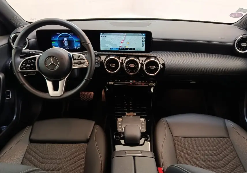 Vue intérieure avant de la Mercedes Classe A 250 e Business Line noire, avec tableau de bord numérique et écran tactile central.