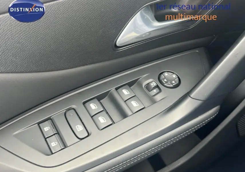 Gros plan sur la commande des vitres électriques côté conducteur de la Peugeot 308 2024, intérieur noir avec surpiqûres blanches.