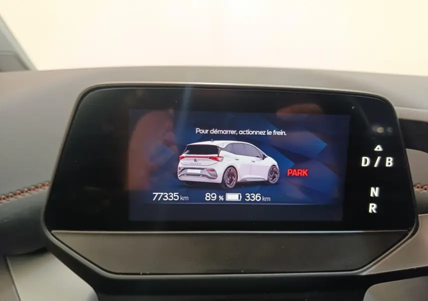Écran digital du tableau de bord montrant une illustration arrière blanche du CUPRA Born avec autonomie et kilométrage.