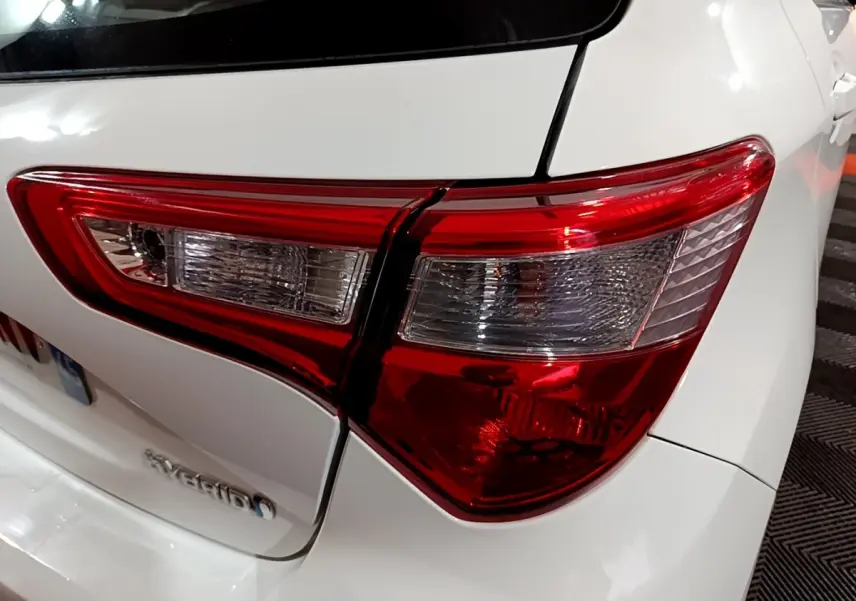 Gros plan sur le feu arrière droit rouge et blanc d'une Toyota Yaris hybride blanche de 2019.