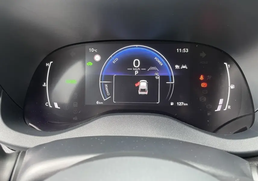 Affichage numérique du combiné d'instruments de la Toyota Yaris Cross 1.5 Hybrid, vue frontale, avec indicateurs de vitesse et alertes.