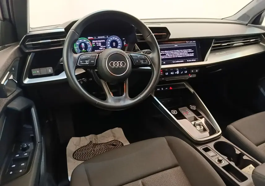 Vue intérieure avant de l'Audi A3 40 TFSI e 2022, volant cuir multifonctions et grand écran tactile central.