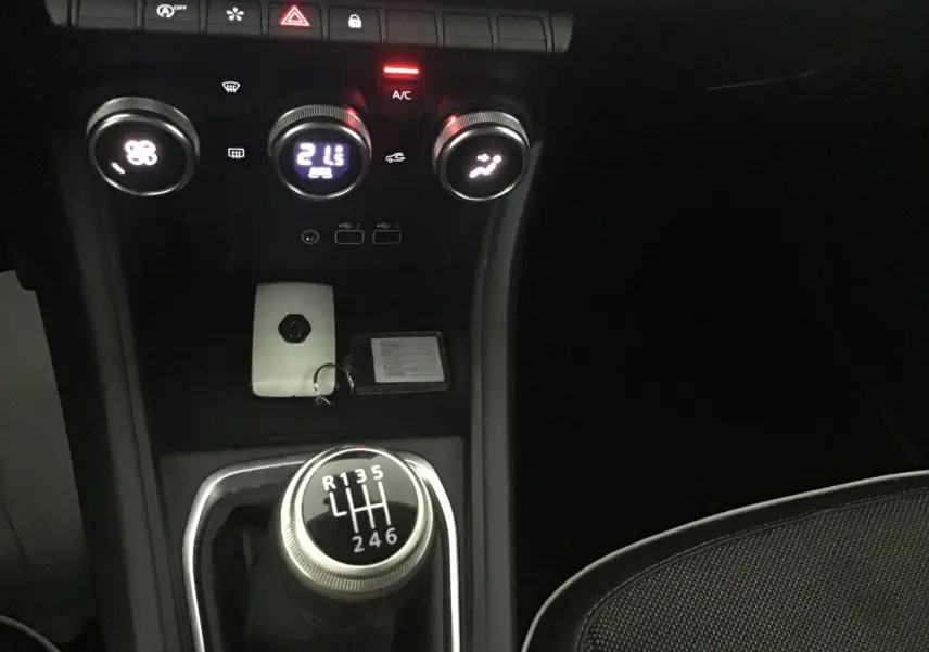 Vue rapprochée de la console centrale du Renault Captur 2024 avec levier de vitesse manuel et commandes climatisation.
