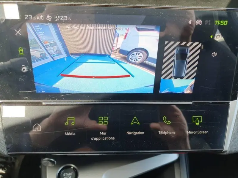 Écran tactile de la Peugeot 308 Hybrid blanc montrant la caméra de recul avec vue arrière et top-down.