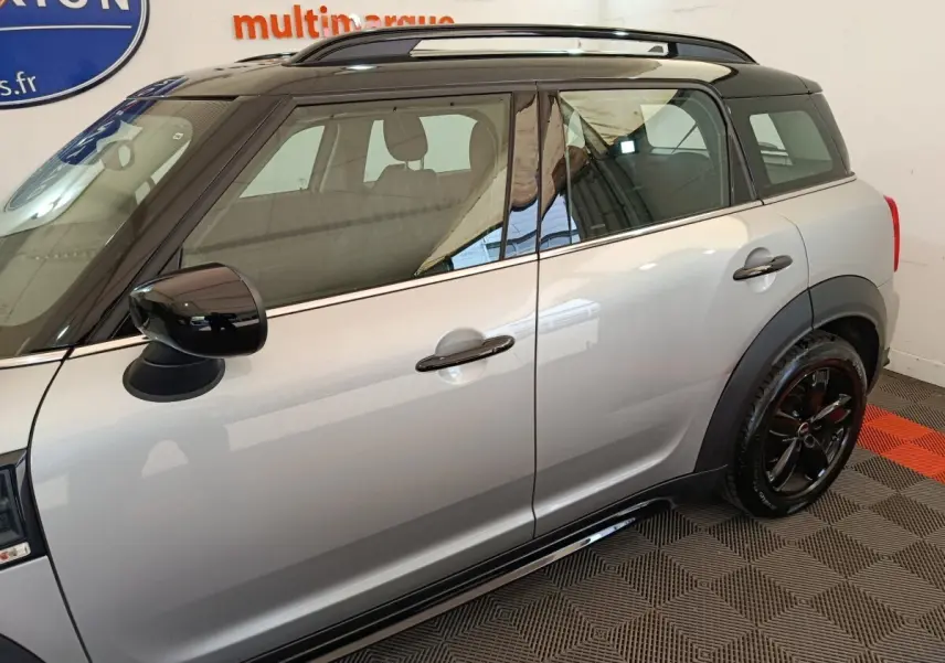 Vue latérale droite d'une MINI Countryman gris foncé avec toit noir et jantes noires brillantes.