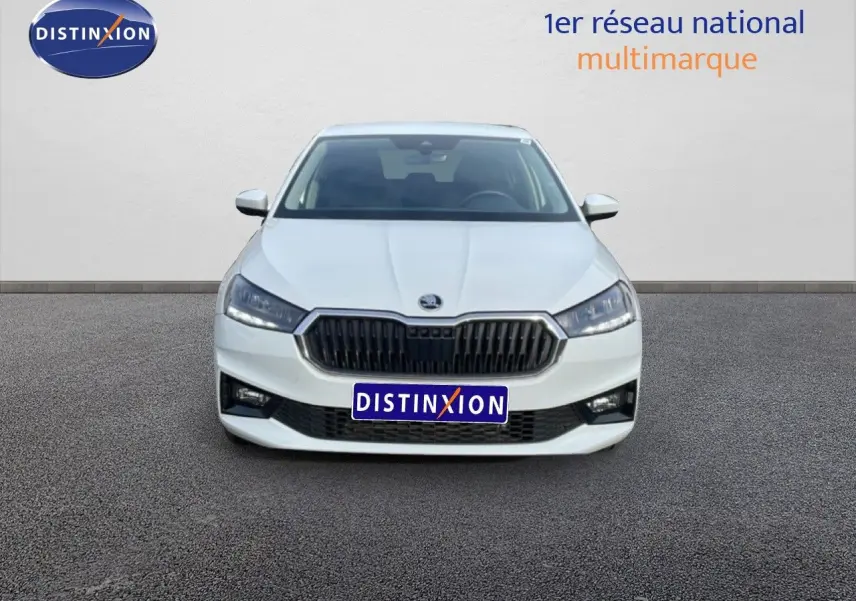 Vue avant d'une Skoda Fabia blanc glacier 2025 avec calandre noire et phares LED allumés.