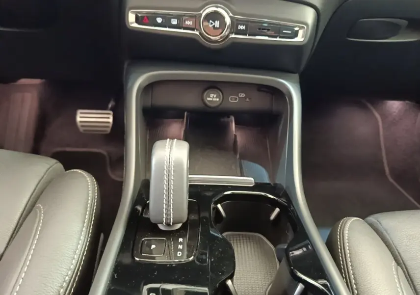 Vue rapprochée de la console centrale du Volvo XC40 P8 R-Design 2021, avec levier de vitesse et commandes audio.