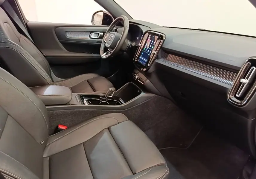 Vue intérieure côté conducteur du Volvo XC40 P8 408 R-Design 2021, montrant sièges cuir noirs et écran tactile vertical.