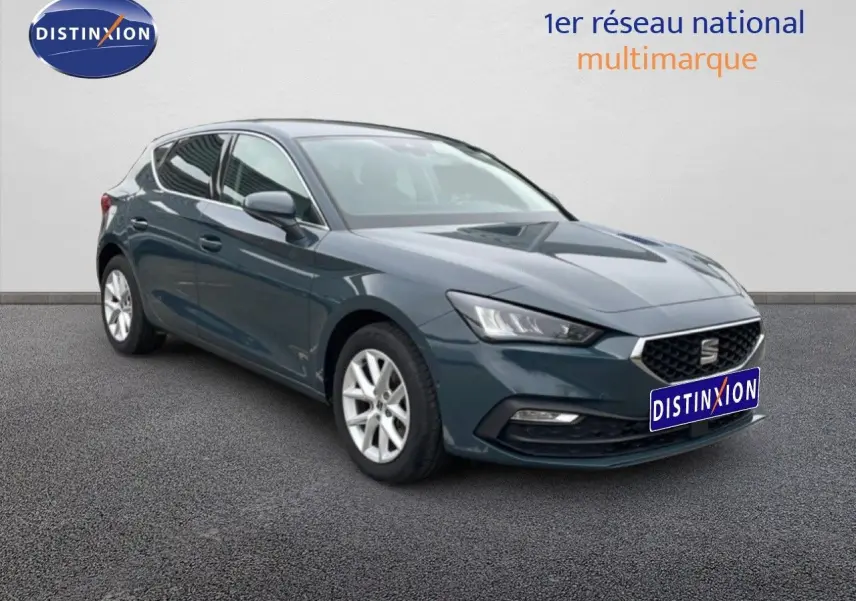 SEAT Leon 2.0 TDI 115ch Style XL gris magnétique, vue 3/4 avant droit avec calandre et phares LED visibles.