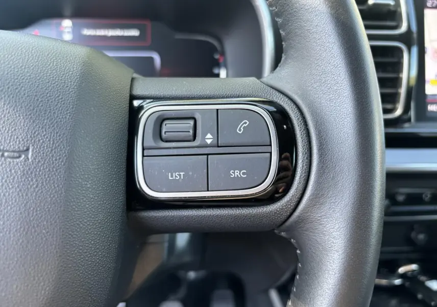 Gros plan sur les commandes au volant à droite du Citroën C5 Aircross 2019 noir métallisé, avec boutons de téléphone et audio.