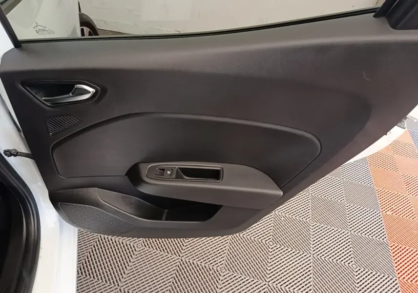 Vue intérieure de la porte avant gauche noire d'une Renault Clio blanche 2023, avec poignée argentée et commande de vitre.