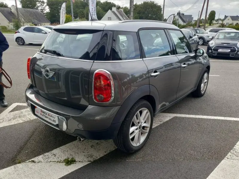 MINI Countryman Cooper D 2014 gris Royal, vue 3/4 arrière droit avec jantes alu et barres de toit visibles.