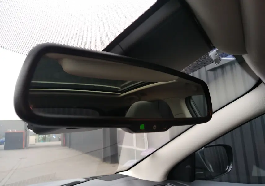 Rétroviseur intérieur du Nissan Qashqai 2019, vue centrée avec indication LED verte et toit ouvrant visible en reflet.
