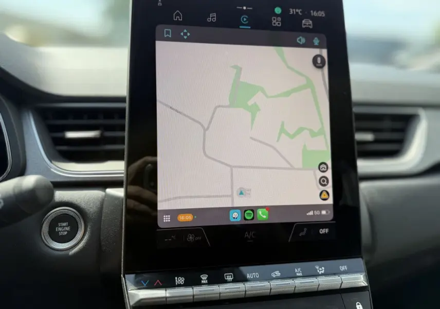 Écran tactile central du tableau de bord du Renault Captur 2025, affichant la navigation GPS en mode clair.
