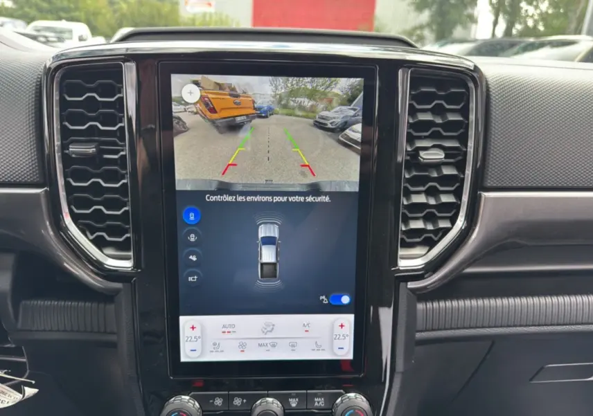 Écran tactile central du Ford Ranger 2025 gris carbone montrant la caméra de recul et les capteurs de stationnement.