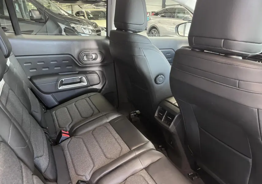 Vue intérieure arrière côté droit du Citroën C5 Aircross gris, sièges tissu et cuir noir avec surpiqûres.