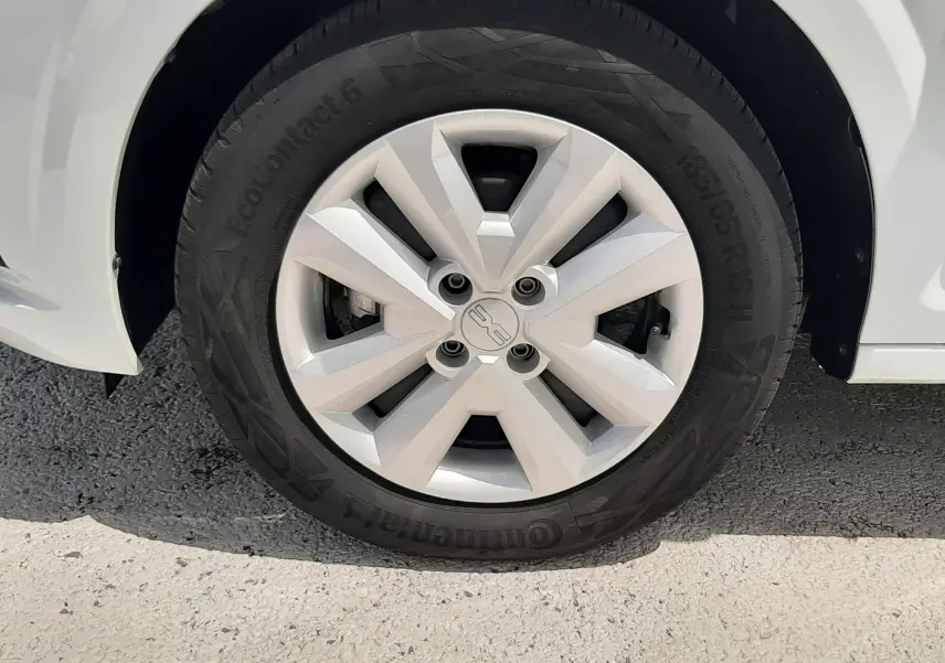 Gros plan sur la roue avant droite blanche glacier d'une Dacia Sandero 2024 avec jante en alliage et pneu Continental.